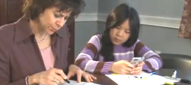 Woman and child reading documents