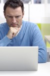 Man reading at a computer Man reading at a computer